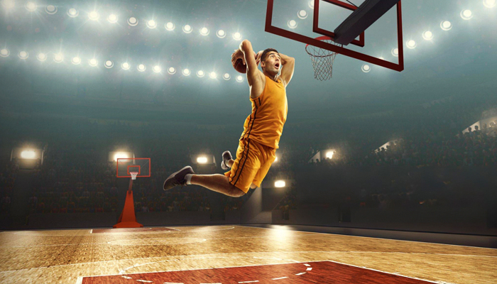 Sports Photography: Freeze the Moment, Capture the Thrill 1 Young muscular basketball player with a ball on floodlight professional court scoring a goal